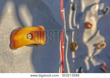 Bright Orange Foothold Or Handhold Of A Climbing Wall At A Playground
