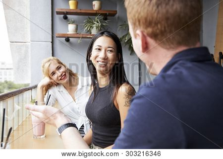 Pretty Young Women Listening To Inetresting Story Of Their Friend