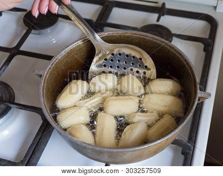 Preparation Of Arabic Dessert Tulumba In Boiling Oil. Tulumba- Arabian Syrup-soaked Fried Sponge Hon