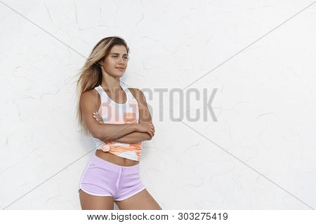 Satisfied Confident Peaceful Young Sportswoman Wearing Sportswear, Cross Arms Over Chest, Smiling En