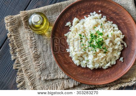 Portion Of Risotto On The Wooden Table: Top View