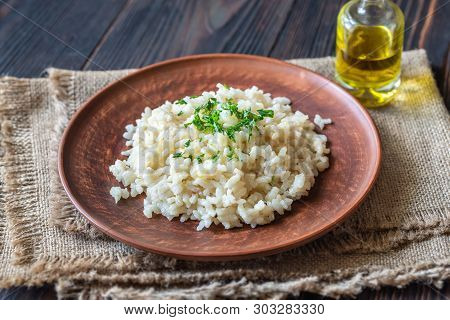 Portion Of Risotto On The Wooden Table