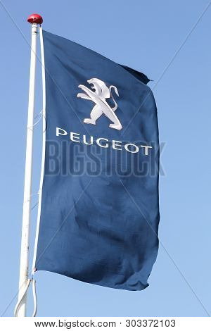 Risskov, Denmark - May 11, 2019: Peugeot Logo On A Flag. Peugeot Is A French Cars Brand, Part Of Psa
