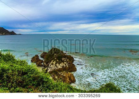 Scenic Cannibal Bay. Pacific coast of the South Island. New Zealand. Powerful ocean surf. The concept of ecological, active and phototourism