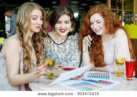 Smiling Girls Discussing A Thesis. Project Work. Concept Of Lifestyle, Friendship, Study And Work.