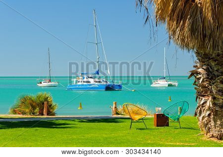 An Idyllic Place To Relax With Beautiful Water And Sailing Boats On Anchor In The Background - Monke