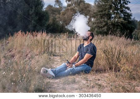 Stylish Smoker Vaping An Electronic Cigarette. Alternative To Smoking.