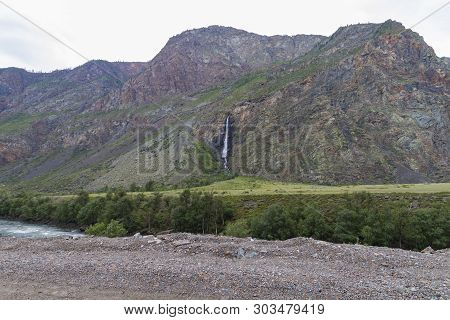 Waterfall In Altay Mountains. Beautiful Nature River Landscape.