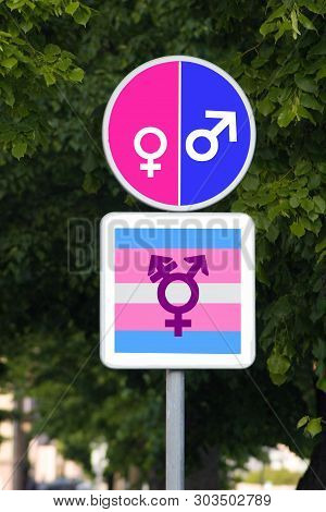 All Welcome. Differences Are Tolerated. A Command Road Sign With A Female Gender Symbol On One Pink 