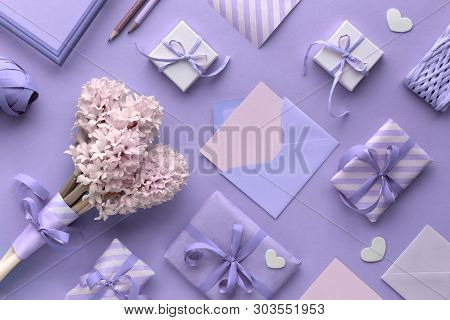 Springtime Violet  Background With Pink Tulips, Hyacinth, Wrapped Gift Boxes And Decorative Hearts