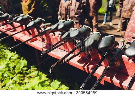 Paintball Guns On A Wooden Table. Play Paintball.