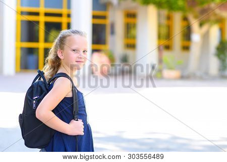 Portrair Happy Smiling Kid Back To School. Child Little Freckles Girl With Bag Go To Elementary Scho