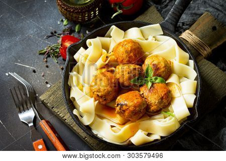 Fettuccine Pasta And Homemade Beef Meatballs In Tomato Sauce In A Frying Pan On Dark Stone Table. Fr