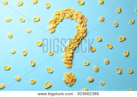 Yellow Flakes In The Shape Of A Question Mark On A Blue Background. How To Choose Cereal For Breakfa