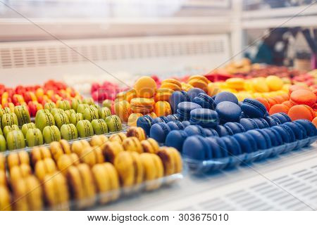 Assortment Of Colorful Macaroons On Cafe Showcase. Variety Of Macaron Flavours. Sweet Almond Cakes I
