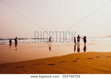 Karpasia, Cyprus - 14 April, 2019: Atmospheric Capture Of Silhouettes Of People Playing In Beautiful