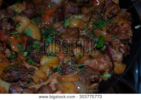 Baked Potatoes In A Cauldron With Meat. Meat Dish. Baked Potato.
