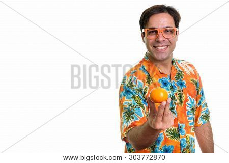 Studio Shot Of Young Happy Persian Tourist Man Smiling And Holdi