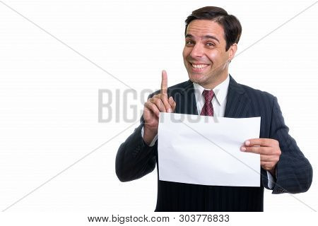 Studio Shot Of Young Happy Persian Businessman Smiling And Holdi