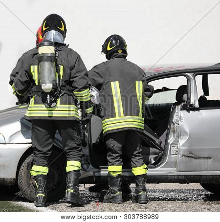 Brave Firefighters During An Operation With The Cylinders After The Road Accident