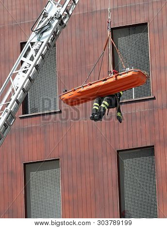 One Firemen During A Rescue With Stretcher