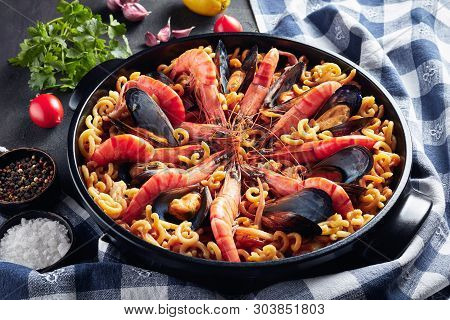Spanish Fideua, A Noodle Paella With Seafood - King Prawns, White Fish Meat, Calamari, Mussels In A 