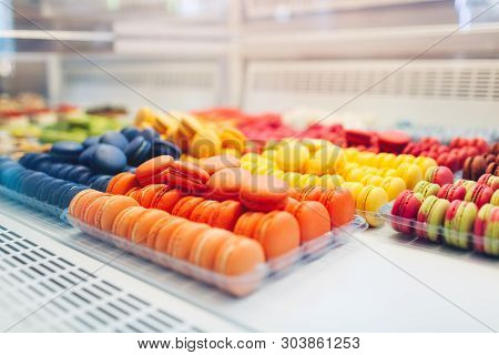 Assortment Of Colorful Macaroons On Cafe Showcase. Variety Of Macaron Flavours. Sweet Almond Cakes I