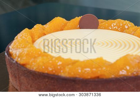Close-up Of Round-shaped Homemade Cake With Fondant Icing And Sugar Tangerine Slices. Delocious Dess