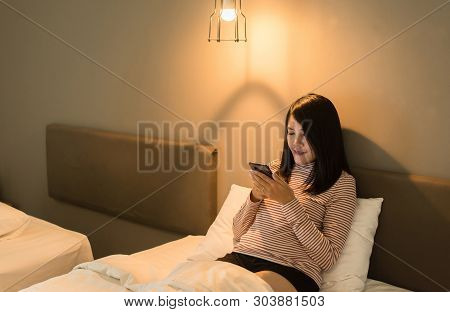 Beautiful Asian Woman Using Smartphone On Bed At Night,eye Diseases And Eyes Disorders Concept