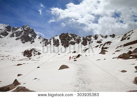 Silhouette Of Hiker In Red On Snowy Plateau In High Mountains At Sunny Day. Turkey, Kachkar Mountain