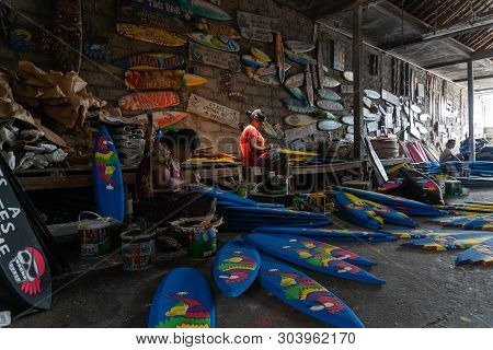 Ubud/bali-april 27 2019: Two Female Craftsmen From Ubud Were Making Mini Surf Boat Crafts That Were