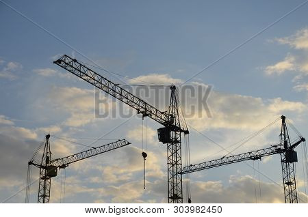 Construction Crane Near The Building Under Construction. Close Up Of A Construction Crane. Self-erec