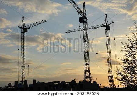 Construction Crane Near The Building Under Construction. Close Up Of A Construction Crane. Self-erec