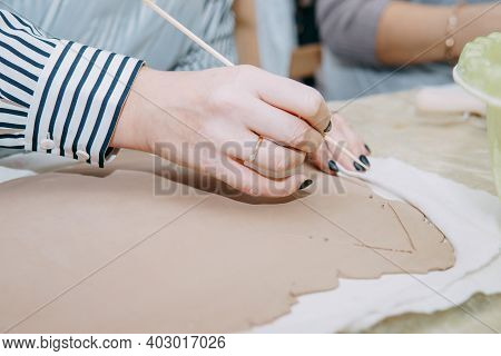 Womens Hands Knead Clay, Drawing Elements Of The Product. Production Of Ceramic Products At The Mast