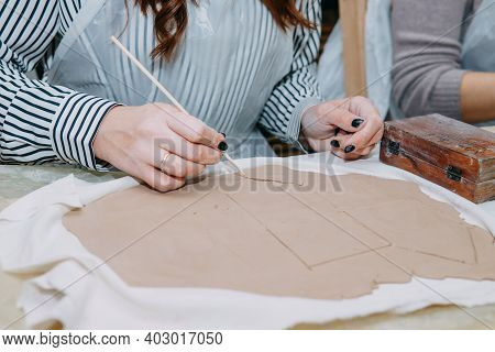 Womens Hands Knead Clay, Drawing Elements Of The Product. Production Of Ceramic Products At The Mast
