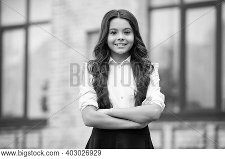 Dedicated To Learning. Confident Lyceum Student Keep Arms Crossed Outdoors. Happy Child Study In Lyc