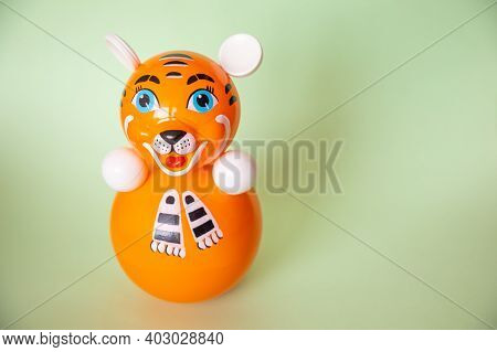 Bright Plastic Toy-tumbler As Orange Tiger On Green Background