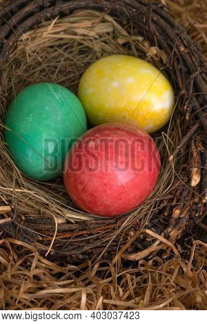Colorful Boiled Estern Chicken Eggs In A Nest On A Dark Background.