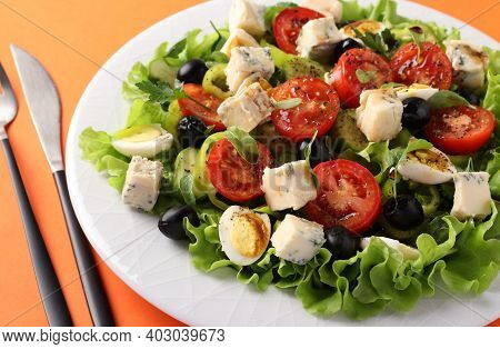Healthy Salad Of Cherry Tomatoes, Cucumbers, Peppers, Black Olives, With Olive Oil, Quail Eggs And G