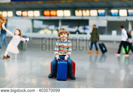 Cute Little Kid Boy With Luggage, Two Suitcases On International Airport. Mother With Little Girl Da