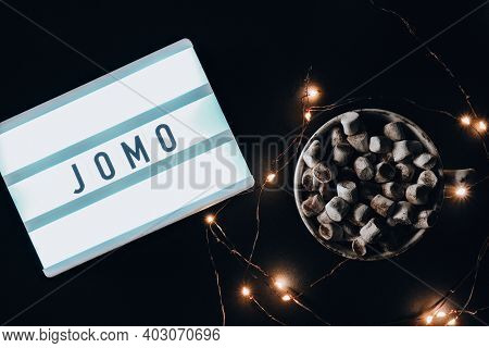 Lightbox With Text Jomo Joy Of Missing Out. The Concept Of Relaxation From Information And Gadgets.