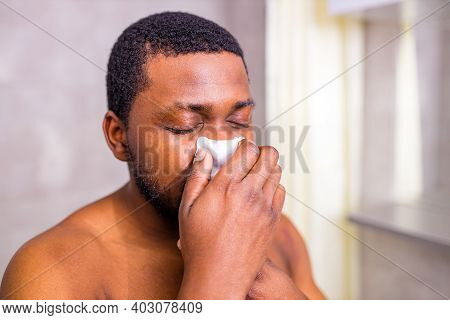 African American Man Snot Symptom Feeling Bad Stay At Home Looking At Mirrror In Bathroom