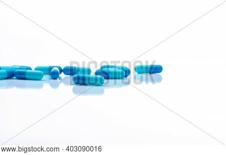 Selective Focus On Blue And White Capsules Pill On White Background. Antibiotics Drug Resistance. An