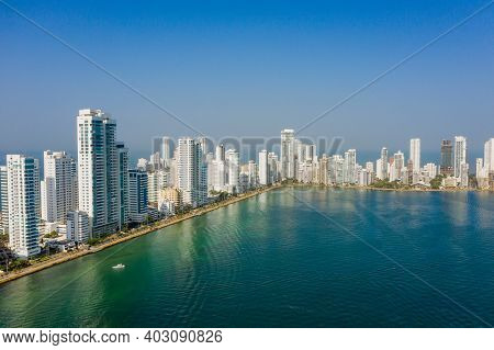 Skyscraper With White Facades At A Bright Sunny Day On The Blue Sky Background. Economy Finances And