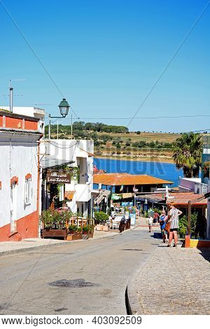 Alvor, Portugal - June 7, 2017 - Village Street With Views Towards The Fish Market And Estuary, Alvo