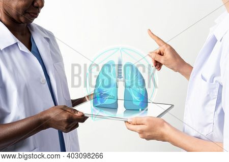 Doctors using transparent tablet with hologram medical technology