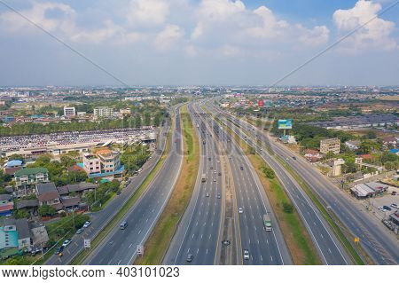Aerial View Of Cars Driving On Highway Or Moterway. Overpass Bridge Street Roads In Connection Netwo