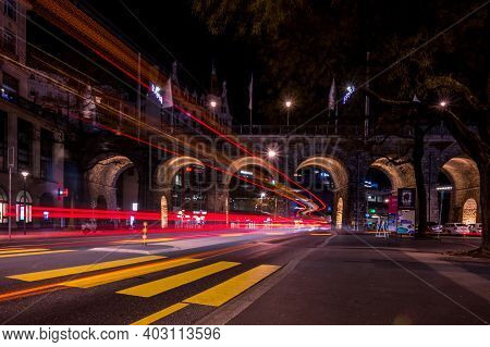 Lausanne, Vaud , Switzerland - 01.10.2021: Car Light Trails Over Lausanne City At Night. Beautiful A