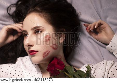 Sexy Brunette Woman With Kisses, Lipstick Marks On Her Face And Neck, With Red Rose. Girlfriend, Dat