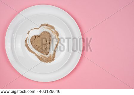 Collagen Powder Or Protein Is Scattered Randomly Over The Surface Of The Plate. Heart Shaped Empty S